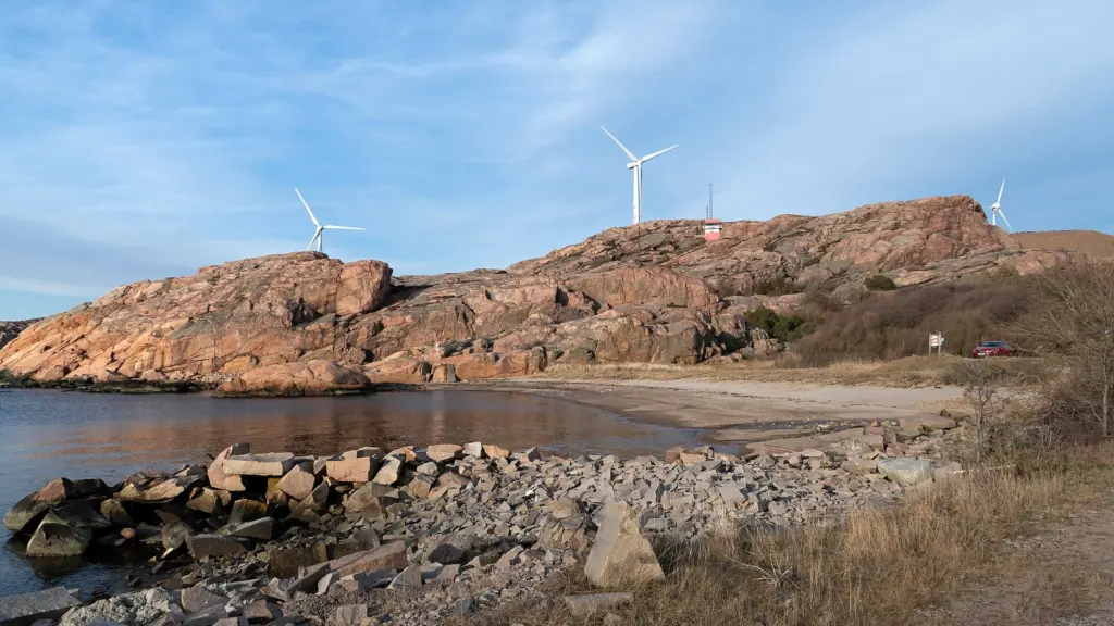The beach and lighthouse up on the cliff in Fiskebäcksvik, Lysekil Municipality, Sweden.