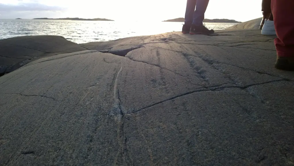 A glacial striation, oriented east-west at the Swedish west coast, at Smithskka udden. Sunset in the background. Showing that the glaciers moved in a westerly d