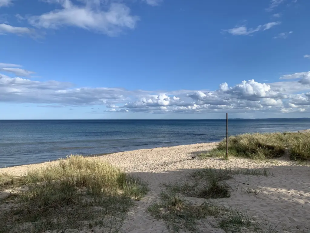 Empty Sandy beach, calm sea and blue skies in Yngsjo south east Sweden